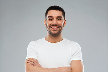 Image showing smiling man with crossed arms over gray background
