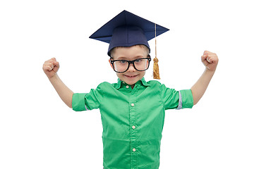 Image showing happy boy in bachelor hat showing power