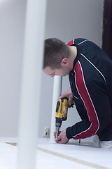 Image showing repairman working with drilling machine