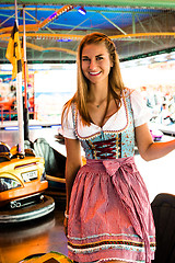 Image showing Beautiful girl leaving an electric bumper car in amusement park