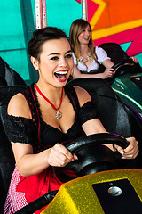 Image showing Beautiful girls in an electric bumper car in amusement park