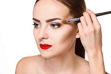 Image showing Beautiful female eyes with bright blue make-up and brush