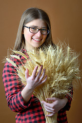 Image showing girl hold in hand bunch of wheat stalks