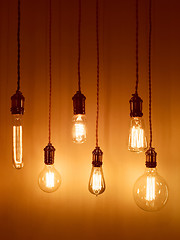 Image showing Light bulbs on warm orange background