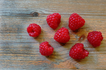 Image showing fresh red berries Raspberry European on a wooden surface