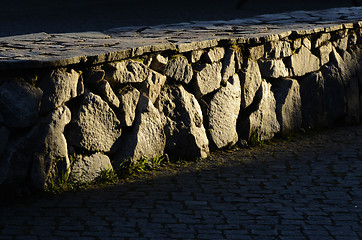Image showing low stone wall and cobblestones