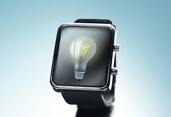 Image showing close up of black smart watch with light bulb