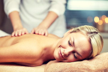 Image showing close up of woman lying and having massage in spa