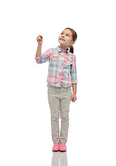 Image showing girl looking up and holding something invisible