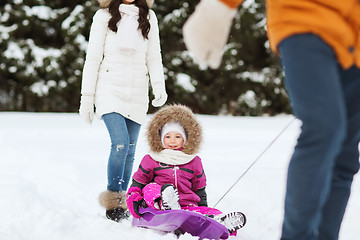 Image showing happy family with sled walking in winter forest