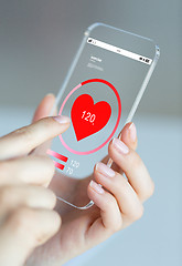 Image showing close up of hand with heart rate on smartphone