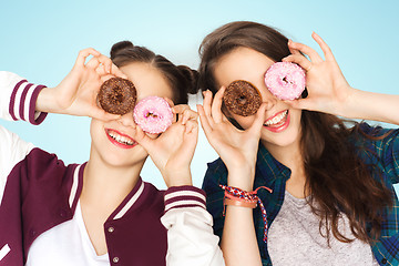 Image showing happy pretty teenage girls with donuts having fun