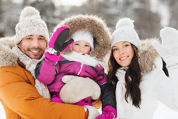Image showing happy family waving hands outdoors in winter
