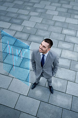 Image showing young smiling businessman outdoors from top