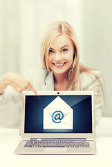 Image showing woman with laptop pointing at email sign