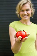 Image showing Cute blond girl presenting vegetables