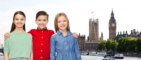 Image showing happy boy and girls hugging over london