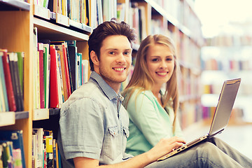 Image showing happy students with laptop in library