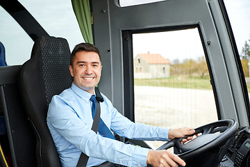 Image showing happy driver driving intercity bus