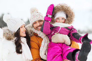 Image showing happy family with child in winter clothes outdoors