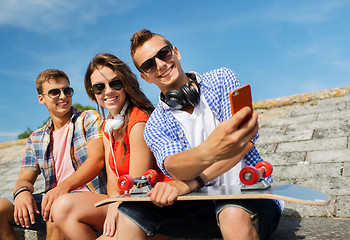Image showing happy friends with smartphone taking selfie