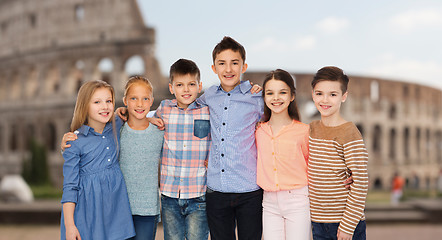 Image showing smiling children hugging over coliseum in rome