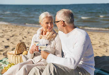 Image showing happy senior couple talking on summer beach