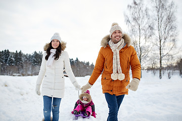 Image showing happy family with sled walking in winter outdoors