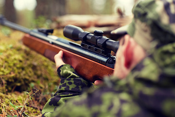 Image showing soldier or hunter shooting with gun in forest