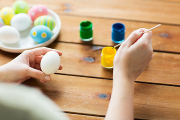 Image showing close up of woman coloring easter eggs