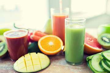 Image showing close up of fresh juice glass and fruits on table