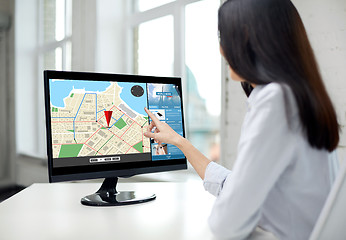 Image showing close up of woman with navigator map on computer