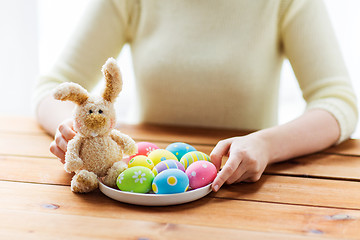 Image showing close up of woman hands with easter eggs and bunny