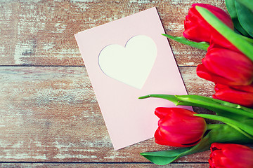 Image showing close up of tulips and greeting card with heart