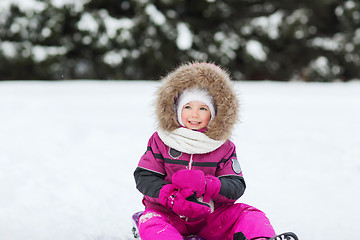 Image showing happy little kid on sled outdoors in winter