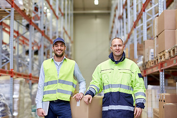 Image showing men in uniform with boxes at warehouse