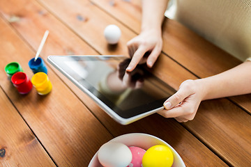 Image showing close up of woman with tablet pc and easter eggs