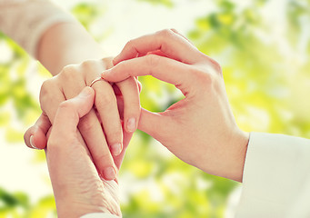 Image showing close up of lesbian couple hands with wedding ring