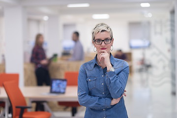 Image showing portrait of young business woman at office with team in backgrou