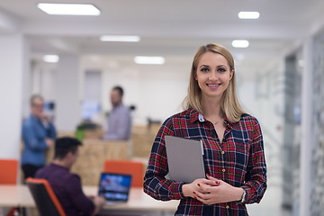 Image showing portrait of young business woman at office with team in backgrou