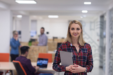 Image showing portrait of young business woman at office with team in backgrou