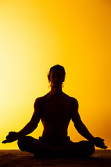 Image showing The man practicing yoga in the sunset light