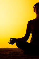 Image showing The woman practicing yoga in the sunset light