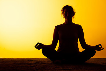 Image showing The woman practicing yoga in the sunset light