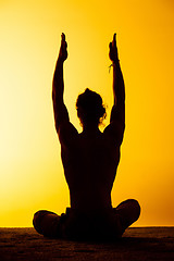 Image showing The man practicing yoga in the sunset light