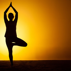 Image showing The woman practicing yoga in the sunset light