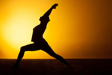 Image showing The woman practicing yoga in the sunset light