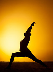 Image showing The woman practicing yoga in the sunset light