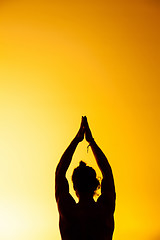 Image showing The man practicing yoga in the sunset light