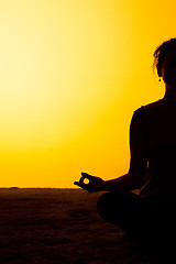 Image showing The woman practicing yoga in the sunset light